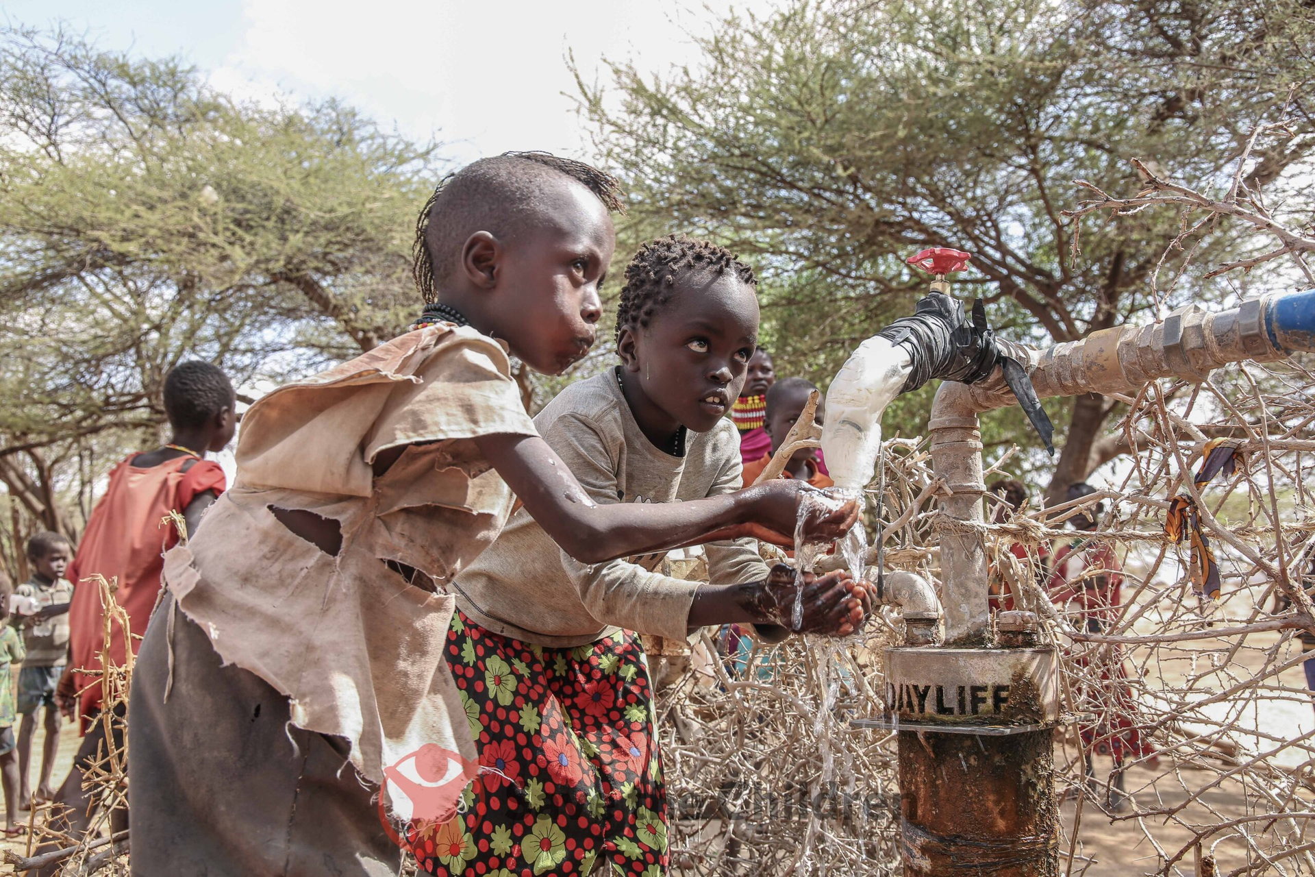 Children collecting water in a rural community setting