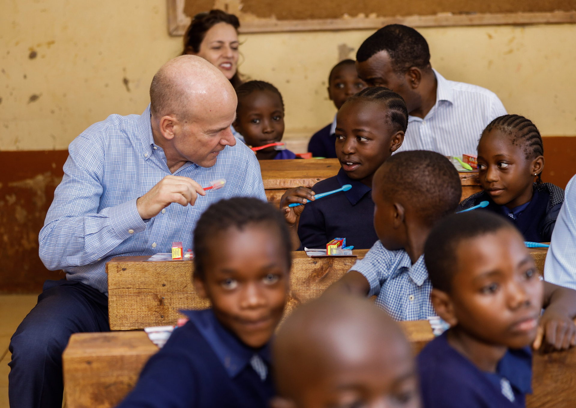 An adult and children sharing a moment in a school setting